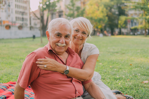 photo of happy elderly couple on park bench