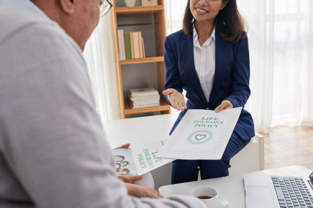 Smiling female manager offering senior couple to take out life insurance