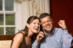 Excited couple listening on cell phone to the benefits of owning life insurance